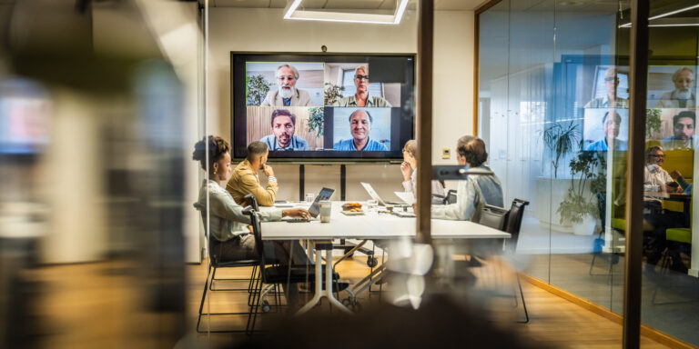 Business people attending a hybrid presentation with remote workers